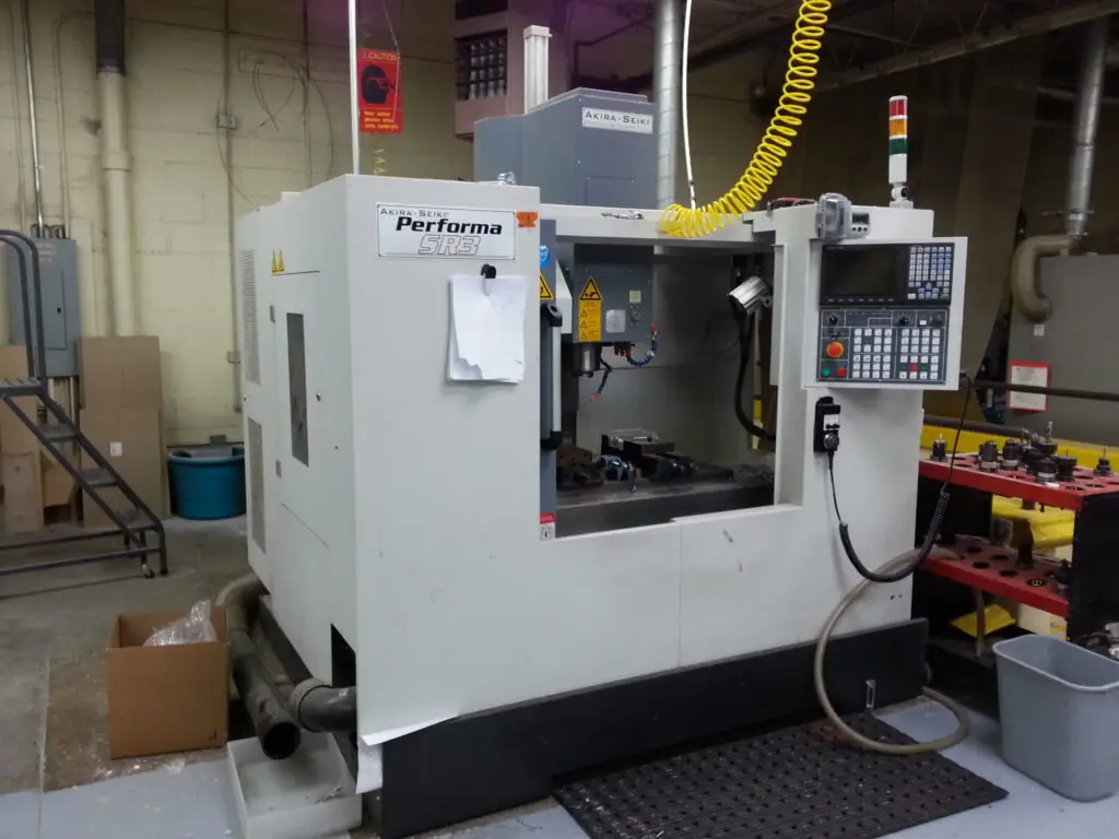 CNC milling machine machining a plastic part at Plastic-Craft Products