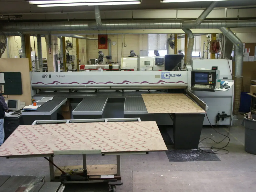 Holzma CNC panel saw cutting masked plastic sheets at Plastic-Craft Products